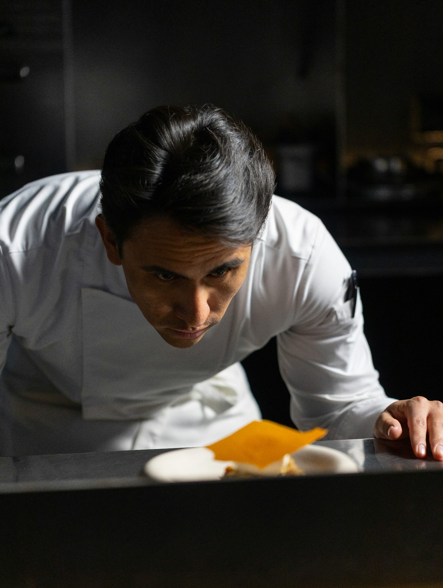 Chef Daniel Reeves in front of the wood-fire grill